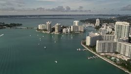 5K aerial stock footage flyby waterfront South Beach condos and hotels to approach Belle Island, Florida Aerial Stock Footage | AX0021_065E