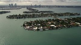 5K aerial stock footage approach and flyby waterfront mansions on one of the Venetian Islands, Florida Aerial Stock Footage | AX0021_067