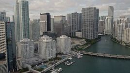 5K aerial stock footage flyby waterfront skyscrapers to reveal Brickell Key Bridge in Downtown Miami, Florida Aerial Stock Footage | AX0021_120E