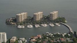 5K aerial stock footage of a trio of condominium complexes on Grove Isle in Miami, Florida Aerial Stock Footage | AX0021_146