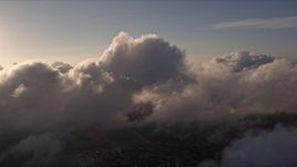 5K aerial stock footage of dense clouds over Miami at sunset, Florida Aerial Stock Footage | AX0022_016