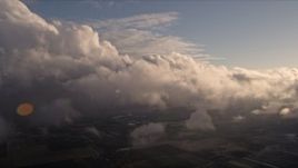 5K aerial stock footage approach the side of a cloud formation at sunset over Miami, Florida Aerial Stock Footage | AX0022_018