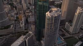 5K aerial stock footage fly over modern high-rise to approach Epic Hotel and Wells Fargo Center in Downtown Miami at sunset, Florida Aerial Stock Footage | AX0022_030E