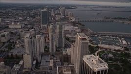 5K aerial stock footage tilt to reveal and approach skyscrapers in Downtown Miami at sunset, Florida Aerial Stock Footage | AX0022_032