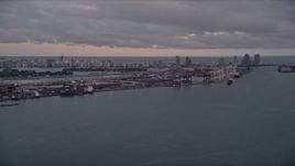 5K aerial stock footage of Port of Miami seen from Biscayne Bay at sunset in Florida Aerial Stock Footage | AX0022_060