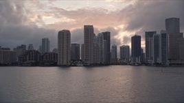 5K aerial stock footage of Downtown Miami coastal skyline at sunset, approach Miami River, Florida Aerial Stock Footage | AX0022_061E