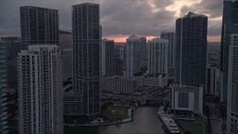 5K aerial stock footage fly over Miami River to approach Icon Brickell and Brickell on the River in Downtown Miami at sunset, Florida Aerial Stock Footage | AX0022_064E