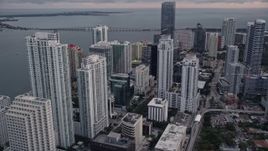 5K aerial stock footage of skyscrapers by the shore of the bay in Downtown Miami at sunset, Florida Aerial Stock Footage | AX0022_067E