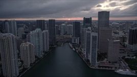 5K aerial stock footage of Miami River and riverfront skyscrapers at sunset in Downtown Miami, Florida Aerial Stock Footage | AX0022_083E