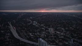 5K aerial stock footage of Coral Way suburban neighborhoods with setting sun on horizon in Florida Aerial Stock Footage | AX0022_093