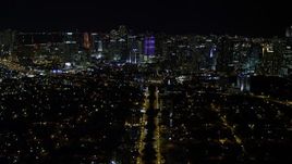 5K aerial stock footage tilt from SW 3rd Ave to reveal colorful Downtown Miami skyline at night, Florida Aerial Stock Footage | AX0023_003E