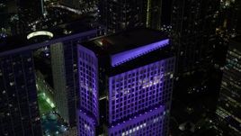 5K aerial stock footage approach the roof of Brickell World Plaza in Downtown Miami at night, Florida Aerial Stock Footage | AX0023_010E