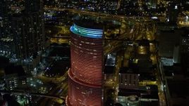 5K aerial stock footage of Miami Tower with colorful lights at night in Downtown Miami, Florida Aerial Stock Footage | AX0023_014E