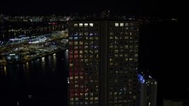 5K aerial stock footage approach and orbit Southeast Financial Center in Downtown Miami at night, Florida Aerial Stock Footage | AX0023_018E