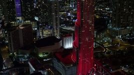 5K aerial stock footage of Miami Tower changing colors at night in Downtown Miami, Florida Aerial Stock Footage | AX0023_027