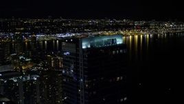 5K aerial stock footage approach and orbit Four Season Hotel tower at night in Downtown Miami, Florida Aerial Stock Footage | AX0023_031E