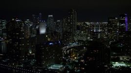 5K aerial stock footage flyby skyscrapers on Brickell Key in Downtown Miami at night, Florida Aerial Stock Footage | AX0023_049E
