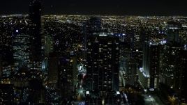 5K aerial stock footage of Jade at Brickell Bay overlooking the water at night in Downtown Miami, Florida Aerial Stock Footage | AX0023_053