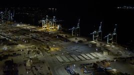 5K aerial stock footage approach cargo cranes and ship at the Port of Miami at night, Florida Aerial Stock Footage | AX0023_060E