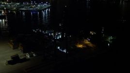 5K aerial stock footage approach Pilot Boat Docks at the end of the Port of Miami at night, Florida Aerial Stock Footage | AX0023_064