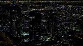 5K aerial stock footage of a trio of modern skyscrapers at night in South Beach, Florida Aerial Stock Footage | AX0023_068