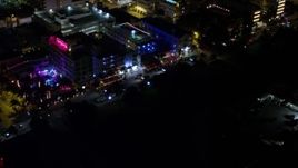 5K aerial stock footage of passing by hotels and Ocean Drive at night in South Beach, Florida Aerial Stock Footage | AX0023_076E