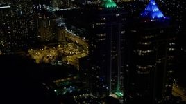 5K aerial stock footage orbit the Blue and Green Diamonds skyscrapers with lighting at night in Miami Beach, Florida Aerial Stock Footage | AX0023_089E