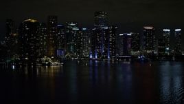 5K aerial \video tilt from the bay to reveal waterfront towers of the Downtown Miami at night, Florida Aerial Stock Footage | AX0023_153E