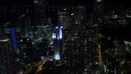 5K aerial stock footage tilt from elevated rail and office building to reveal skyscrapers at night in Downtown Miami, Florida Aerial Stock Footage | AX0023_158E