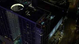 5K aerial stock footage approach 500 Brickell and tilt to rooftop pool at night in Downtown Miami, Florida Aerial Stock Footage | AX0023_168