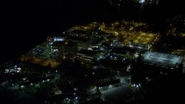 5K aerial stock footage approach Mercy Hospital at night in Coconut Grove, Florida Aerial Stock Footage | AX0023_183E