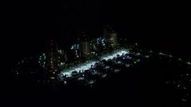 5K aerial stock footage of waterfront condominium complexes at night on Grove Isle, Florida Aerial Stock Footage | AX0023_185