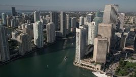 5K aerial stock footage of flying by coastal skyscrapers and reveal Miami River, Downtown Miami, Florida Aerial Stock Footage | AX0024_041E