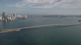 5K aerial stock footage reverse view of Rickenbacker Causeway and reveal Downtown Miami, Florida Aerial Stock Footage | AX0024_050