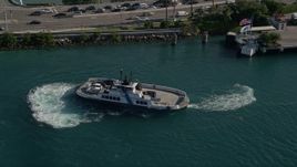 5K aerial stock footage of flying by a ferry turning on Government Cut, Miami Beach, Florida Aerial Stock Footage | AX0024_070