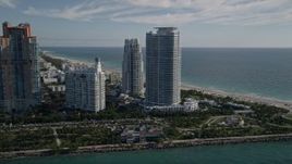 5K aerial stock footage of flying by Portofino Tower and skyscrapers, South Beach, Miami Beach, Florida Aerial Stock Footage | AX0024_075
