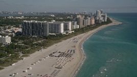 5K aerial stock footage of flying over the beach and past South Beach hotels, Miami Beach, Florida Aerial Stock Footage | AX0024_080E
