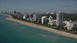 5K aerial stock footage of flying by hotels, apartment buildings, beach, Miami Beach, Florida Aerial Stock Footage | AX0024_089
