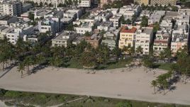 5K aerial stock footage of flying by palm trees at Lummus Park, South Beach, Miami Beach, Florida Aerial Stock Footage | AX0024_095