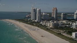 5K aerial stock footage of flying by the beach, approaching skyscrapers, South Beach, Miami Beach, Florida Aerial Stock Footage | AX0024_096
