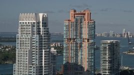 5K aerial stock footage of flying by Portofino Tower and skyscrapers, South Beach, Miami Beach, Florida Aerial Stock Footage | AX0024_097