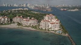 5K aerial stock footage of flying by condominium complexes, Fisher Island, Florida Aerial Stock Footage | AX0024_099