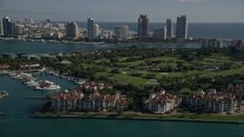 5K aerial stock footage of flying by Fisher Island Golf Course, Fisher Island, Florida Aerial Stock Footage | AX0024_100