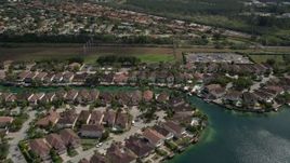5K aerial stock footage of flying by canal side homes in Three Lakes, Miami, Florida Aerial Stock Footage | AX0025_002