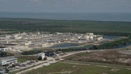 5K aerial stock footage of flying by the  South District Wastewater Treatment Plant, Homestead, Florida Aerial Stock Footage | AX0025_010