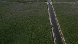 5K aerial stock footage flyby canal, reveal length of canal and Mangrove Preserve, Homestead, Florida Aerial Stock Footage | AX0025_016