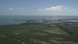 5K aerial stock footage of flying by power lines, revealing Turkey Point Power Plant, Homestead, Florida Aerial Stock Footage | AX0025_020