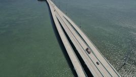 5K aerial stock footage follow Overseas Highway bridge over Lake Surprise, reveal Key Largo, Florida Aerial Stock Footage | AX0025_054
