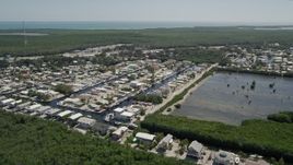 5K aerial stock footage of flying by waterfront homes on canals, Key Largo, Florida Aerial Stock Footage | AX0025_056