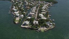 5K aerial stock footage of approaching homes on shore of Sexton Cove, Key Largo, Florida Aerial Stock Footage | AX0025_058